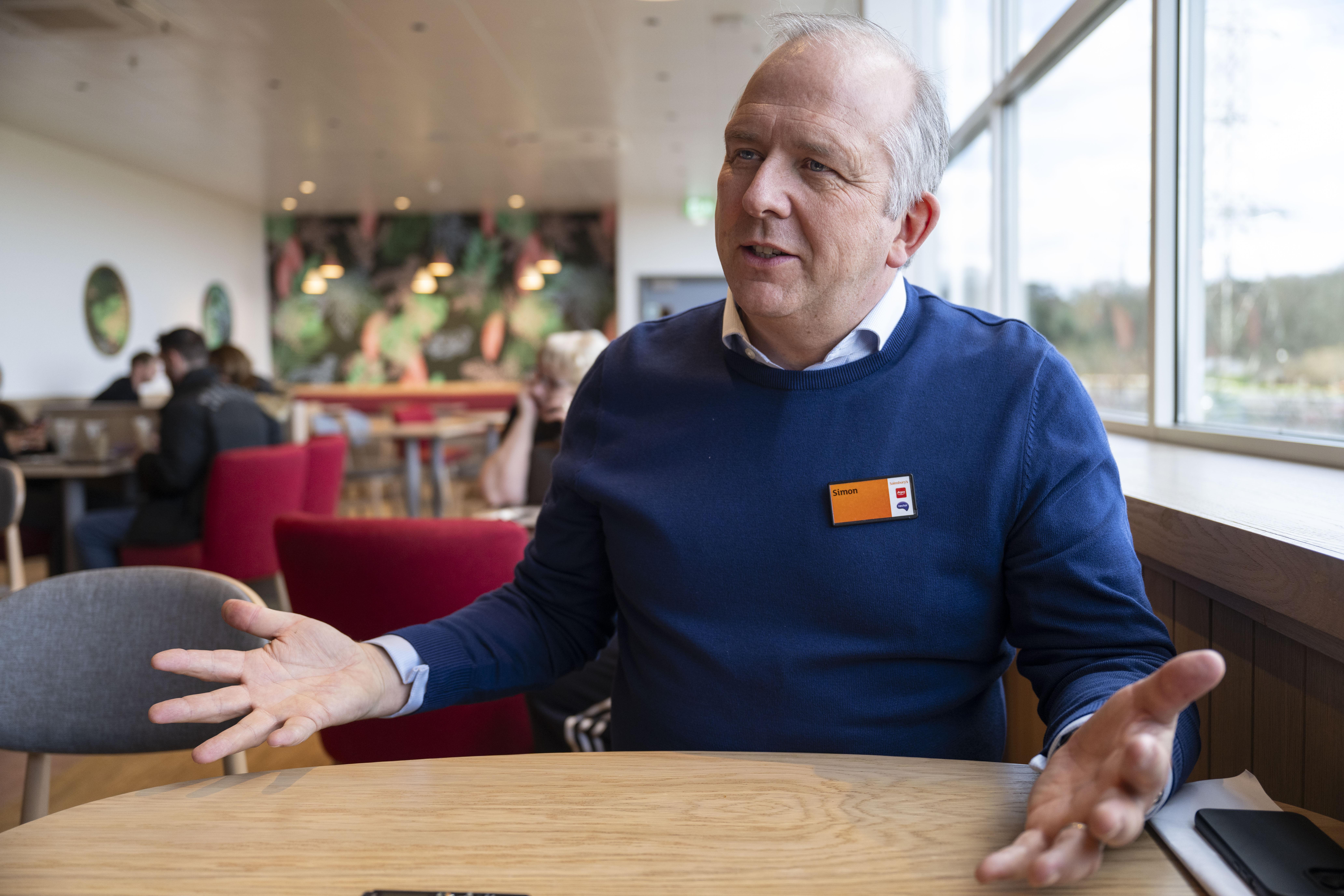 Simon Roberts, CEO of Sainsbury's, speaking at a cafe.