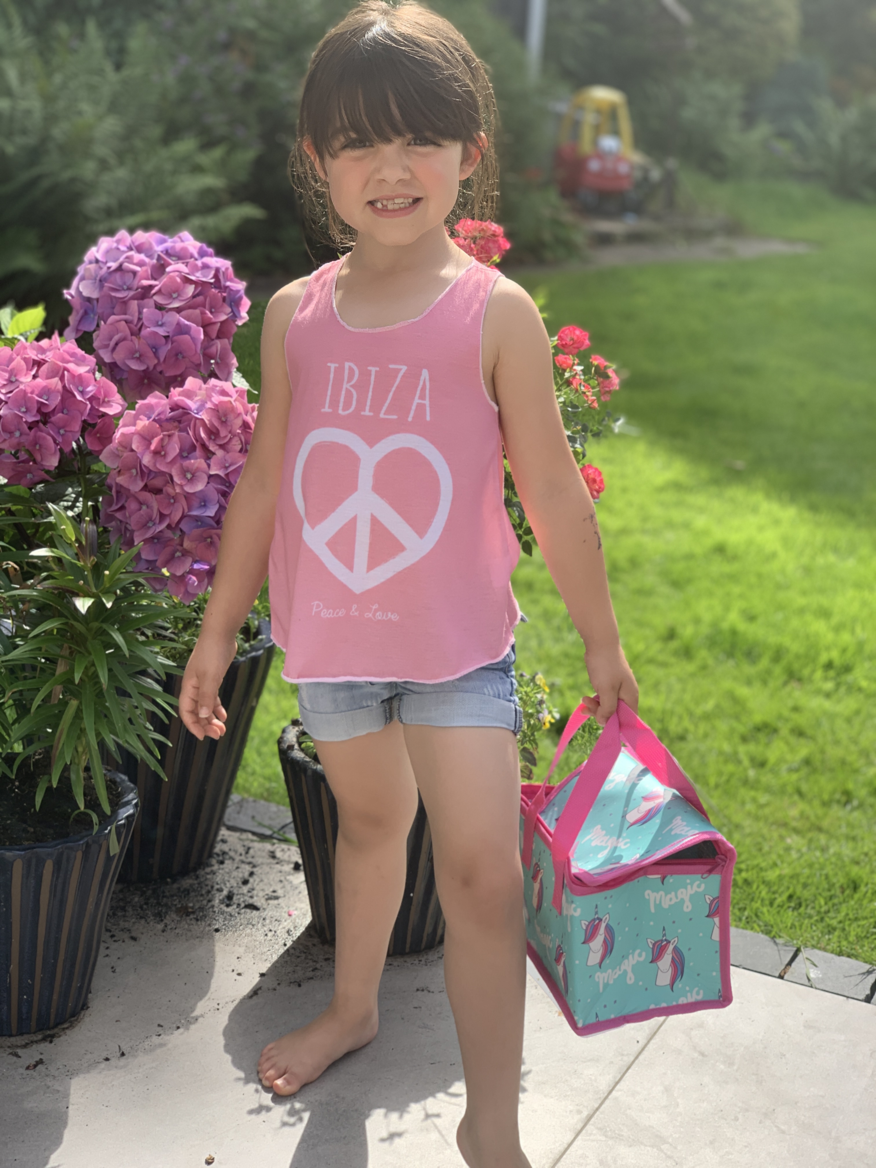 Girl carrying a unicorn-themed party bag.