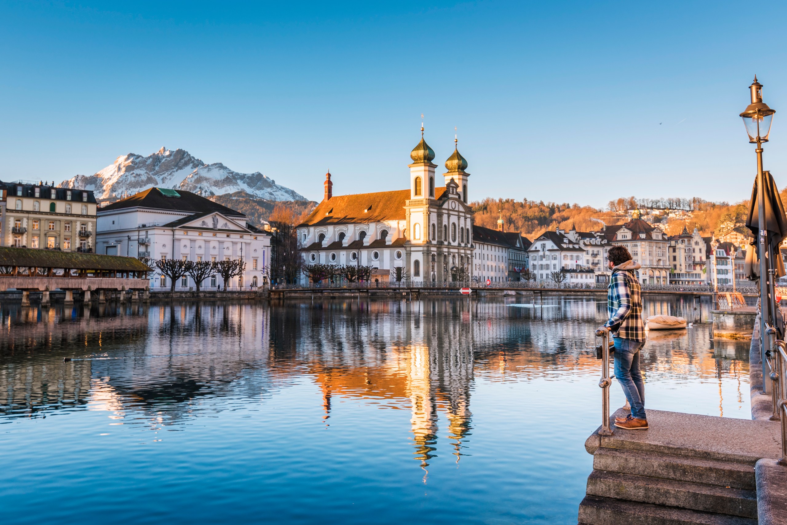 A person by the banks of the Reuss river in Lucerne