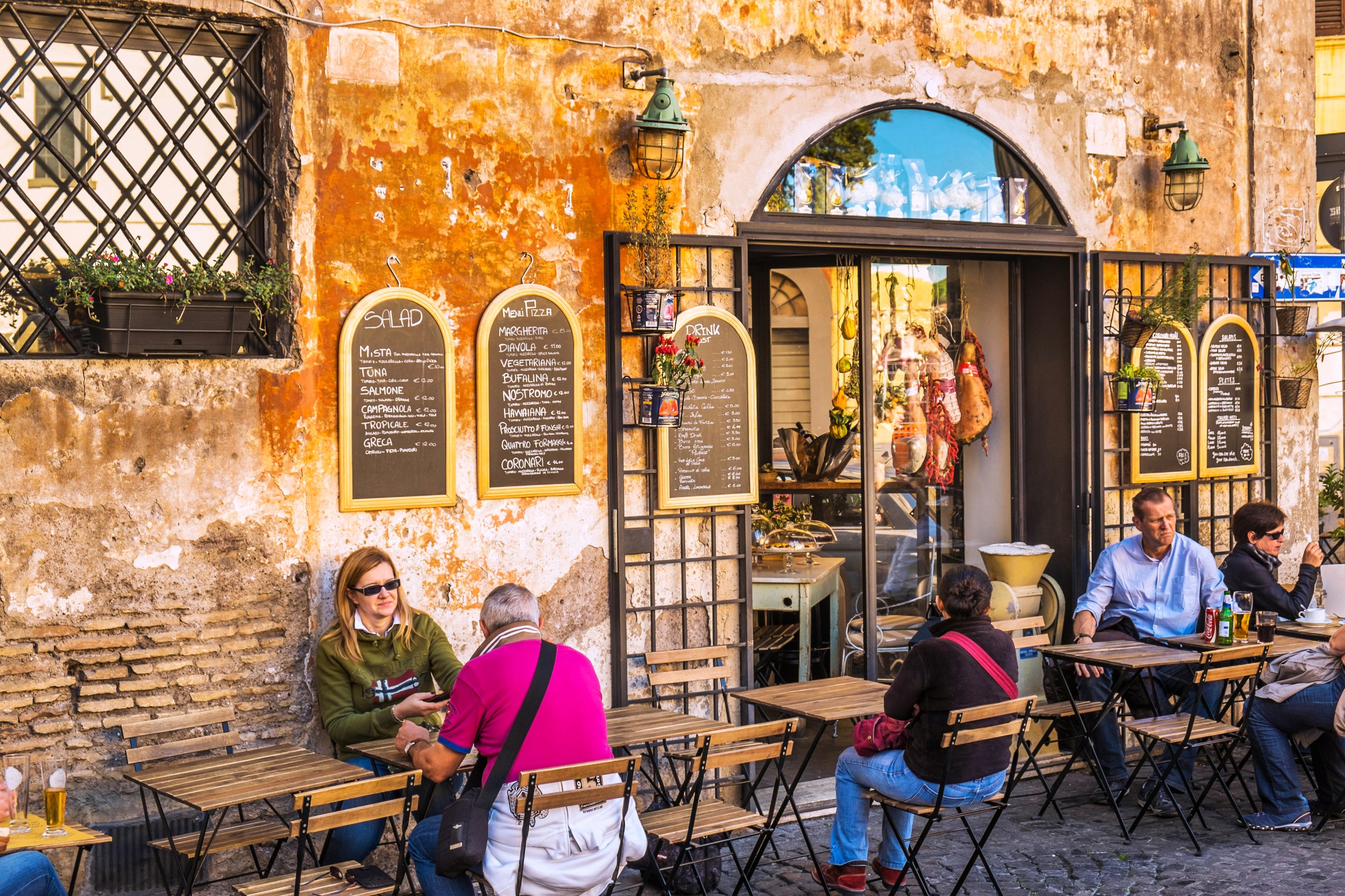 People outdoors at a café in Rome